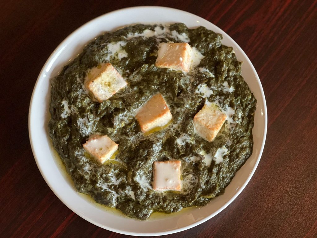 Palak Paneer served with fresh spinach and paneer cubes